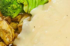 hand-breaded chicken breast takes center stage, deep-fried to a perfect golden brown, creating a symphony of crispy perfection. with gravy, mashed potatoes, vegetable