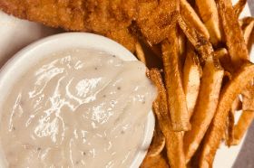 Comforting meal featuring tender steak fingers, breaded and fried to golden perfection. Served with creamy gravy and a side of crispy fries, this dish brings the taste of classic country cooking to your plate