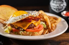 the ultimate remedy for those long nights, featuring a sunny side up egg, melted cheddar cheese, and crispy bacon atop a juicy burger patty. This burger isn't just a meal; it's a comforting embrace that rejuvenates and satisfies.