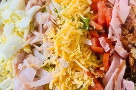 a satisfying and flavorful salad that combines the classic ingredients of a club sandwich with crisp lettuce, juicy tomatoes, and creamy ranch dressing. This salad is a delicious twist on a beloved classic, featuring slices of ham, turkey, and bacon, along with hard-boiled egg, shredded cheese, and a medley of fresh vegetables.